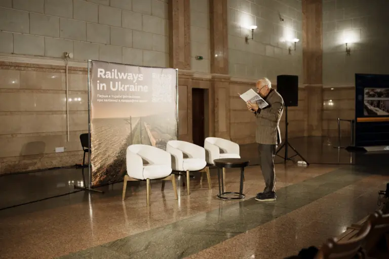 Návštěvník prezentace fotoknihy Railways in Ukraіne od Mykoly Oleksijenka, vydané nakladatelstvím Ukraїner a poprvé představené na kyjivském nádraží v „Bodě neporazitelnosti“. Kyjiv. Červenec 2025. Foto: Jurij Lybenskyj.